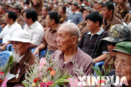 8月30日,在云南省德宏傣族景颇族自治州中缅边境畹町口岸,几名参加过抗战的老兵与云南“自驾车重走滇缅路”活动的志愿者们共同参加纪念抗战胜利60周年活动。畹町是滇缅公路中国境内路段的终点。1939年1月,经20万民工奋力修筑一年、以牺牲3000个同胞生命为代价开辟出的滇缅公路正式通车,成为战时中国大后方唯一的国际通道。当时国内驾驶人员短缺,在南洋侨界号召下,此后半年多里,共有3193名华侨机工回国服务。他们中,有三分之一永远长眠在了滇缅公路这条抗日运输线上。新华社记者曾毅摄