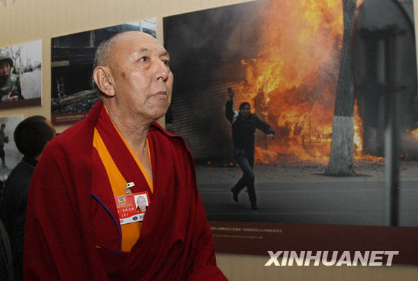 3月11日,出席全国政协十一届二次会议的部分全国政协委员来到北京民族文化宫参观西藏民主改革50年展览。这是来自西藏的全国政协委员宗洛·向巴克珠在观看展览。